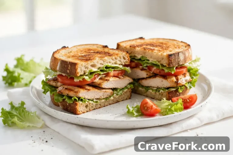 Chicken and vegetable sandwich on a plate.